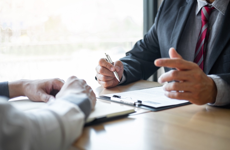 two people talking over documents