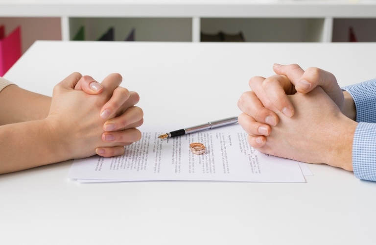 Couple going through divorce signing papers