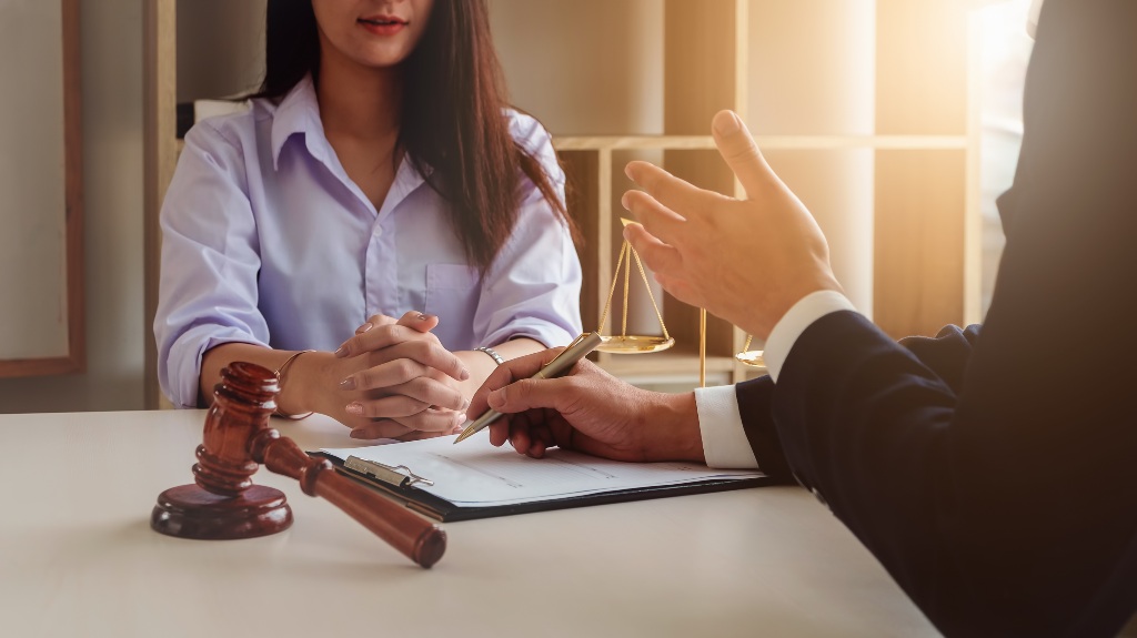 woman talking to a lawyer over paperwork