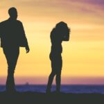 Fighting couple silhouetted at sunset_u