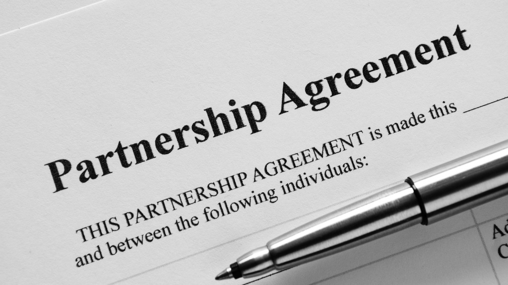 Partnership Agreement document and pen